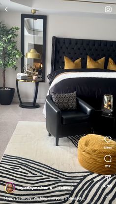 a black and white bedroom with gold accents