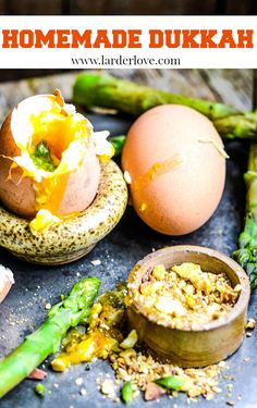 an egg shell and asparagus on a table with the words homemade dukkah