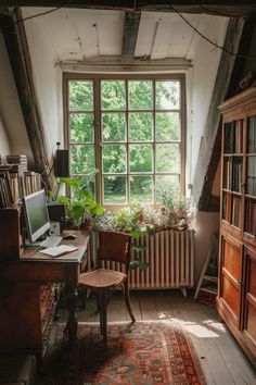 an old fashioned desk and chair in front of a large window with bookshelves