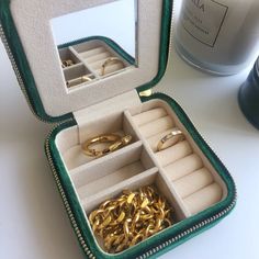 Take your favorite pieces on the go without ever worrying of losing them. A small sized jewelry storage to fit your jewelry essentials for traveling or even a pretty edition on your vanity. A small mirror designed within the jewelry box which makes it perfect for getting ready on the go. Above the mirror is a pull tab to another compartment to hang your dainty necklaces or bracelets. Three hooks with a pouch on the bottom to secure the necklaces. Slots on the left side are adjustable to create d Portable Compact Cosmetic And Toiletry Storage For Everyday, Portable Gold Jewelry Storage For Travel, Trendy Rectangular Cosmetic Storage Gift, Portable Compact Cosmetic And Toiletry Storage, Compact Portable Jewelry Storage For Gift, Compact Portable Jewelry Storage For Everyday, Gold Rectangular Jewelry Storage For Everyday, Rectangular Gold Jewelry Storage For Everyday Use, Elegant Compact Travel Jewelry