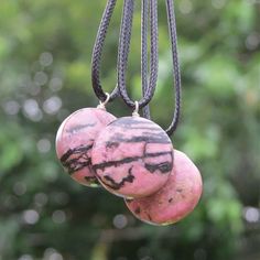 "Large Rhodonite crystal necklace with an round shaped stone of your choice. Each Rhodonite pendant features a beautiful pink and black matrix design across each polished stone and includes a hand wrapped wire bail in Sterling Silver that suspends from an adjustable black cord. Rhodonite Properties Emotional balance - nurtures love - stimulates, clears, & activates the heart - often called the \"first aid\" stone - heals emotional shock & panic - clears wounds & scars from the past - Wishlist Accessories, Matrix Design, Rhodonite Jewelry, Rhodonite Crystal, Dinosaur Jewelry, Dinosaur Necklace, Black Cord Necklace, Love And Forgiveness, Healing Crystal Jewelry