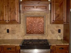 a stove top oven sitting inside of a kitchen next to wooden cupboards and cabinets