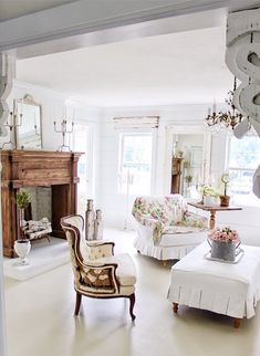 a living room filled with furniture and a fire place in the middle of a room