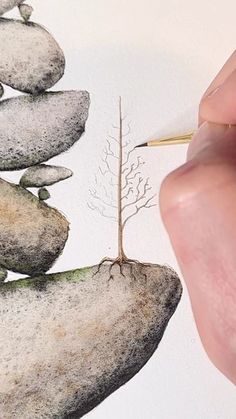 a person is drawing rocks with a pencil