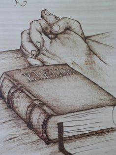 a drawing of a person's hand on top of a book