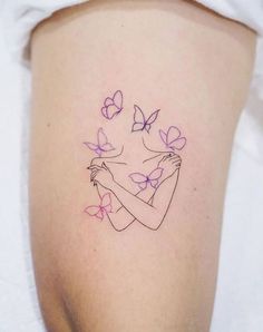 a woman's arm with butterflies on it, and the outline of her breast