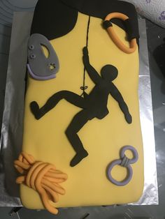 a sheet cake decorated with an image of a climber on a rock climbing wall