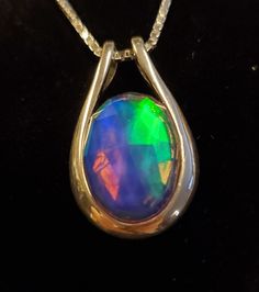 "Amazing Rainbow Aurora Opal Doublet, See Video For Color Spectrum! This Is A Fun Piece! *Stones All Vary Slightly, But Colors And Quality Do Not! 13x18mm Synthetic Opal, 925 Sterling Silver Pendant With 18\" Sterling Silver Chain. Chain Length Options Are Available By Messaging Seller At Time Of Purchase. Gift Box Included." Sterling Silver Necklace With Large Stone For Anniversary, Iridescent Oval Sterling Silver Jewelry, Iridescent Oval Gemstone Necklaces, Iridescent Oval Gemstone Necklace, Iridescent Gemstone Necklace In Sterling Silver, Iridescent Opal Round Jewelry, Nickel-free Opal Necklaces As Gift, Iridescent Moonstone Pendant Jewelry, Opal Necklace Silver