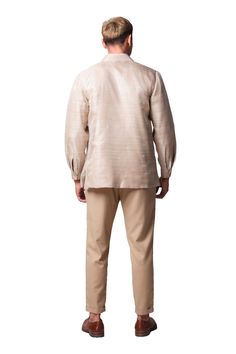 Elevate your formal wear with the Bayani Men's Barong Tagalog. This handcrafted statement piece features intricate ethnic embroidery, luxuriously soft piña fabric woven from pineapple fibers, and a comfortable mocha lining. Inspired by traditional Filipino motifs, the embroidery showcases unique patterns reminiscent of woven mats, sunlight, and fallen leaves. Made-to-order and available in limited quantities, the Bayani Barong Tagalog is a testament to both heritage and innovation. Handcrafted p Silk Long Sleeve Nehru Jacket, Barong Tagalog, Mocha Color, Rich Fabric, Organza Fabric, Ethnic Patterns, Color Lines, Handmade Fashion, Bespoke Design