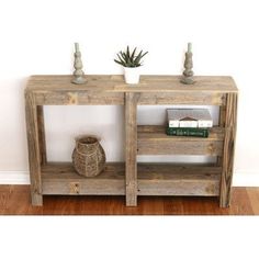 a wooden shelf with some books on top of it next to a potted plant