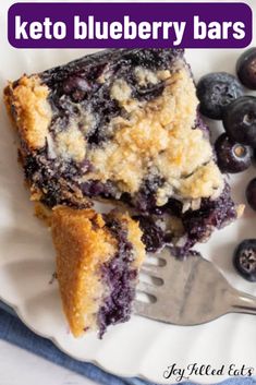 a close up of a plate of food with blueberries and a fork on it