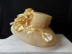 Brand New! Still Ticketed! LILY & TAYLOR "Derby" Hat Decorated With Beautiful Silk Flowers, Swirl Ribbon, And Tasteful Rhinestones. Absolutely stunning "Derby" hat, wedding hat, graduation hat, Church, the Easter hat, tea parties, the Kentucky Derby, the Preakness or the Belmont...whatever fabulous spring, summer event you can think of...this is your perfect hat! And, it's unworn! *       Beautiful, buttery yellow *       100% light, comfortable, natural materials *       Crown is decorated with large, rich, silk flowers, curl ribbon rhinestones *       Inner band circumference is 22" *       Measures 19" front to back of hat; inner band measures 8" front to back; 7" side to side *       6" wide beautiful brim LILY & TAYLOR hats are expertly with detail that adds a touch of sophistication Red Hat Ladies, Easter Hat, Easter Hats, Hat Wedding, Graduation Hat, Elegant Hats, Wedding Hat, Derby Hat, Preakness