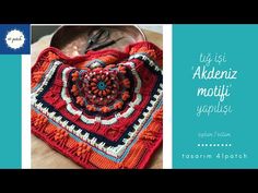 an orange crocheted bag sitting on top of a wooden table