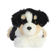 a black and white dog stuffed animal laying down