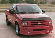 a red truck parked in a parking lot