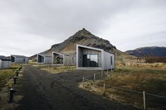 an outhouse in the middle of nowhere with mountains in the background