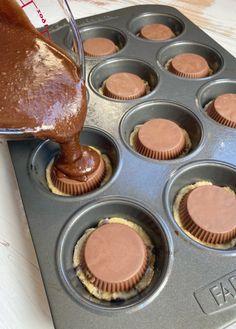 chocolate cupcakes in a muffin tin being filled with batter