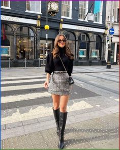 This outfit exudes timeless elegance with a modern edge. The model is dressed in a black turtleneck paired with a high-waisted black and white houndstooth mini skirt. The knee-high black boots add a touch of sophistication, making this a perfect choice for a chic day out in the city.


Photo credit by: @sophielouisesdiary Tweed Set Outfit Winter, Tweed Skirt Outfit Winter, London Outfit Fall, Tweed Shorts Outfit, Boots Skirt Outfit, Houndstooth Skirt Outfit, Tweed Street Style, Fall Styles For Women, Tweed Skirt Outfit