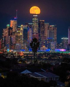 the full moon rises over los angeles, california