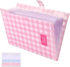 a pink and white checkered paper bag with labels on the front, two different colors