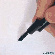 a person holding a pen and writing on a piece of paper with chinese characters below it