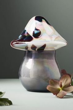 a vase sitting on top of a table next to a flower