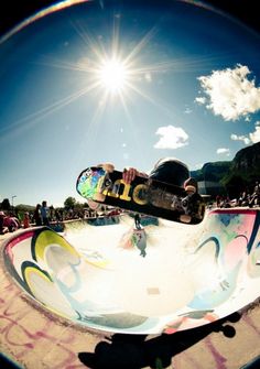 a person on a skateboard in the middle of a bowl at a skate park