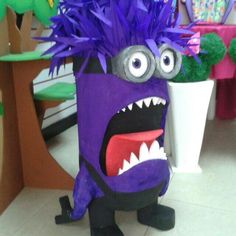 a purple monster is standing in front of a potted plant with its mouth open