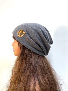 Gray Slouchy Beanie Dark Gray Beanie Knit Hat Womens Mens Beanie Chemo Hat. Designed and handcrafted with great pride in my pet free smoke free studio in Michigan. Material: Stretchy and soft jersey knit cotton in dark gray color. This hat is light weight and super soft. Twisted top design. It has an opening in the back for ponytail or dreadlock. You can easily convert the hat into a neck scarf or face covering for the cold days. Check out my other hippie beanie in the link below: https://www.et Gray Beanie, Twisted Top, Mens Beanie, Chemo Hat, Grey Beanie, Dark Grey Color, Slouchy Beanie, Face Covering, Neck Scarf