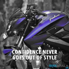 a blue motorcycle parked next to a tree with the words,'confidence never goes out of style '