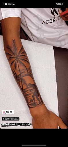 a man with a palm tree tattoo on his arm