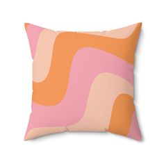 an orange and pink pillow with wavy lines on the front, against a white background