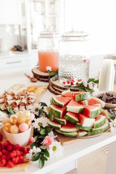 a table topped with watermelon slices and other foods