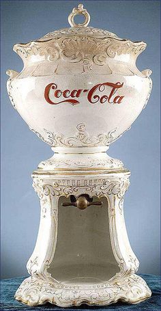 an antique coca - cola machine is on display