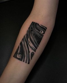 a black and white tattoo design on the left arm with an abstract pattern in it