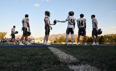 a group of football players standing on top of a field