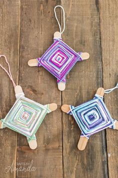 three handmade wooden toys sitting on top of a wooden table