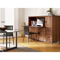 a dining room table with chairs and a computer on it