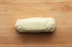 a piece of bread sitting on top of a wooden table