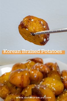 a spoon with some food on it and the words korean braised potatoes above it