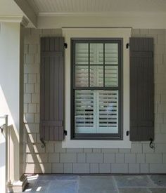 an open window with shutters on the outside