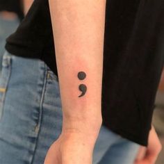 a person with a small tattoo on their arm