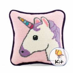 a cross stitch pillow with a unicorn's head on it