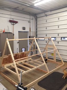 a wooden frame in the shape of a house is being constructed with tools and materials