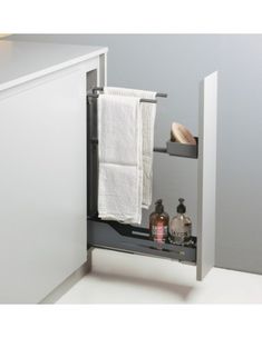 an open cabinet with towels and soaps in it