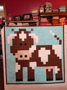 there is a quilt on display in the room with it's animal motif displayed