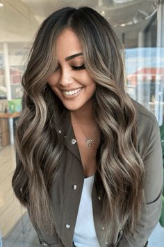 This gorgeous hairstyle for summer features dark brown hair that blends smoothly into highlights the color of caramel, giving it depth and warmth. The hair is worn in loose, flowing waves that make the transition between colors more natural and give it body, capturing the relaxed feeling of the season. With its easy mix of shades, - Click to see more of 38 Stunning Brunette Hair Colors to Elevate Your Summer Look and follow us for more hairstyle ideas. // Photo Credit: Instagram @hairbymkim Brunette Hair With Cool Blonde Highlights, Natural Looking Brunette Balayage, Partial Blonding On Dark Hair, Summer 2024 Balayage, Ash Blonde Balayage Dark Hair, Balayage For Long Dark Brown Hair, Long Dimensional Brunette, Dimensional Brunette Dark Balayage Highlights, Brown Skin Balayage