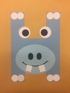 a paper cut out of a hippo with eyes and nose on it's face