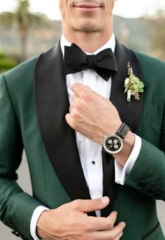 a man in a tuxedo with a flower on his lapel and watch