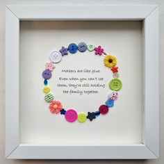 a white frame with buttons in it that says mothers are like glue